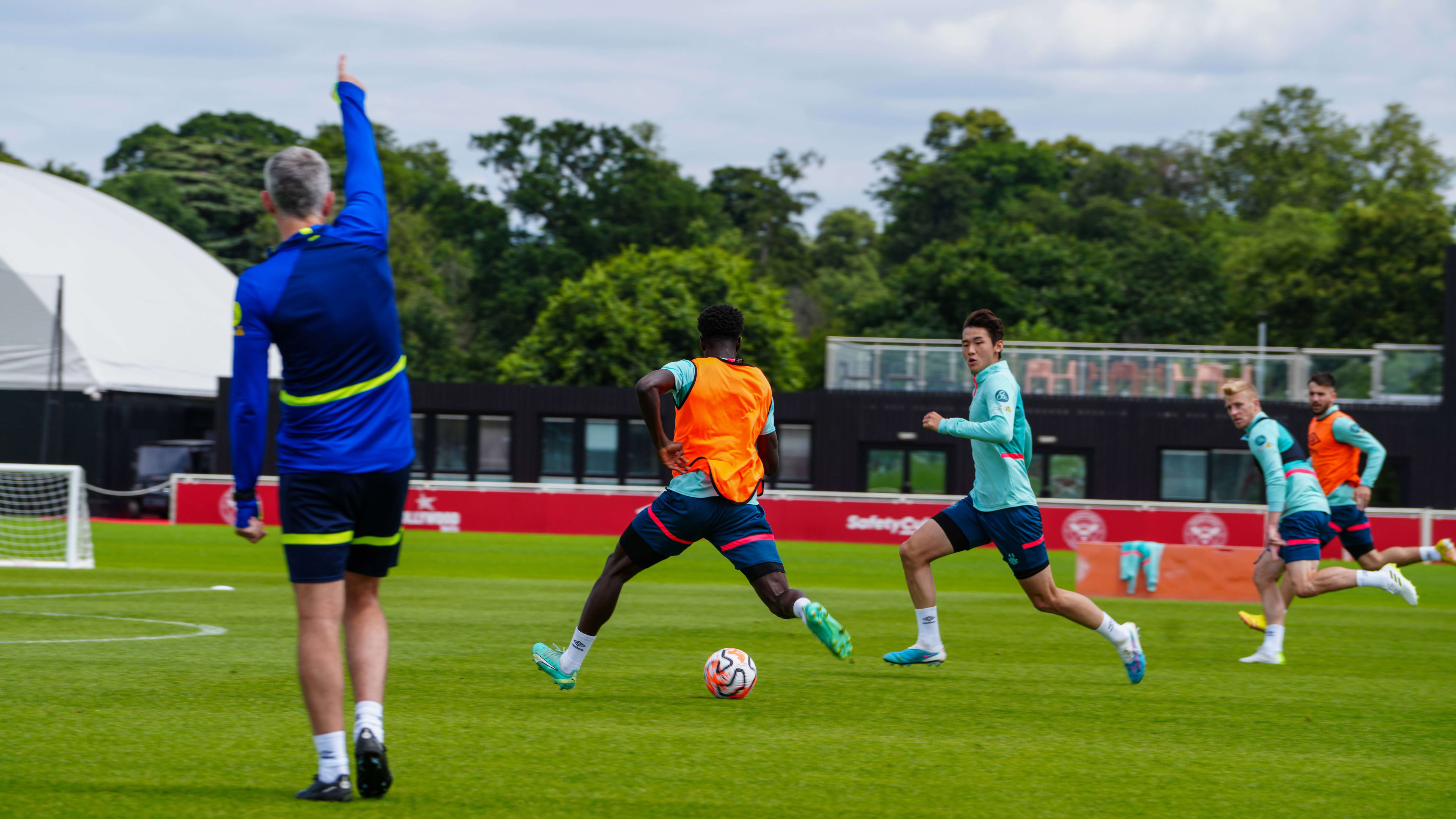 Pulling the trigger: new signing Ji-soo Kim watches on as Michael Olakigbe takes a shot at goal